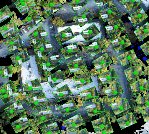 Photogrammetry processing view showing aligned camera positions across a site.