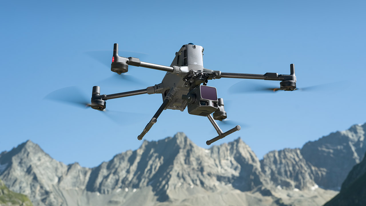 Large lidar-capable drone in flight above a mountainous landscape.
